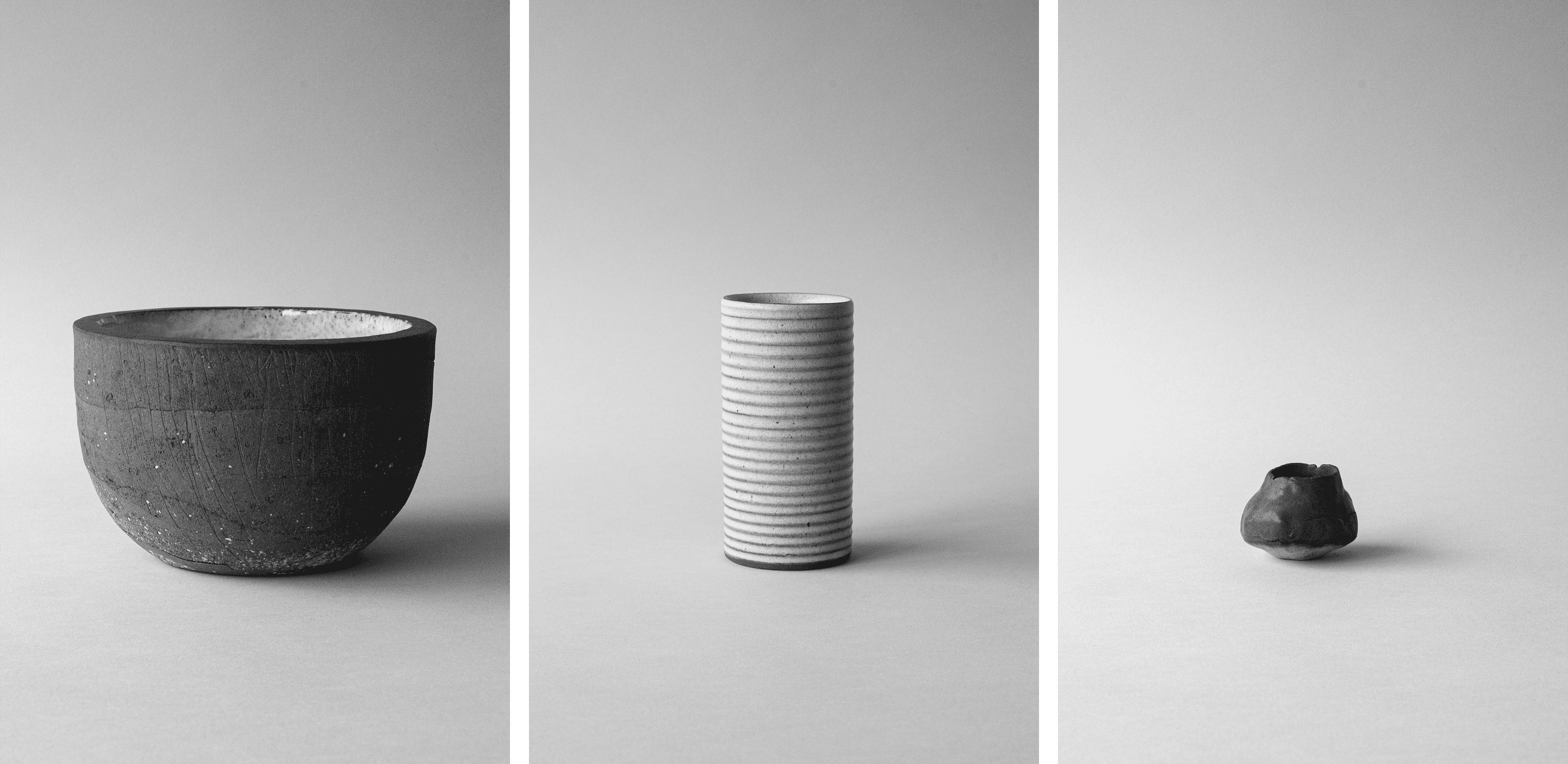 Triptych of:
Stoneware bowl with a rough texture, centered in the frame against a soft, neutral background.
Small, irregularly shaped ceramic bud vase, rough in texture, placed on a neutral surface with lots of negative space.
Tall, cylindrical stoneware vase with horizontal ridges, placed against a minimalist neutral background. by Sydney SG